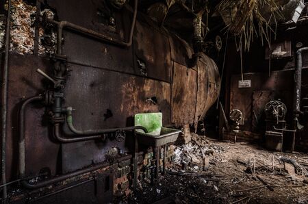 green washbasin with rusty kettleの写真素材