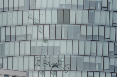 reflection of a crane in many windows