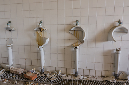 destroyed pissoir in old buildingの写真素材