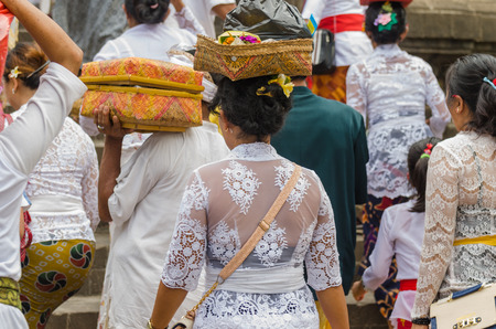 people with colorful clothes and presents in temple on baliのeditorial素材