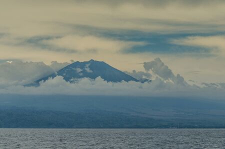 high volcano and clouds on the horizon in Baliの写真素材
