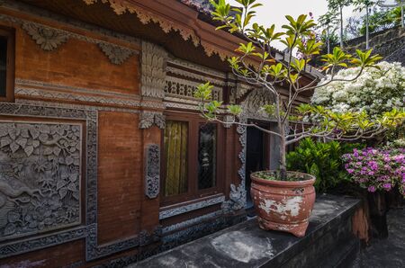wooden buildings with ornaments and bonsai plantsの写真素材