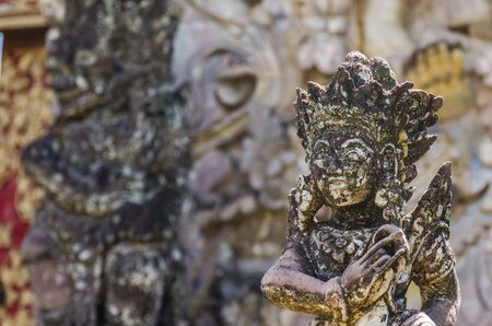 old statue in the pura beji temple detail viewの写真素材