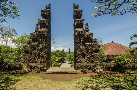 high gate with ornaments of stone in templeの写真素材