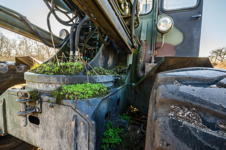old overgrown excavator in nature