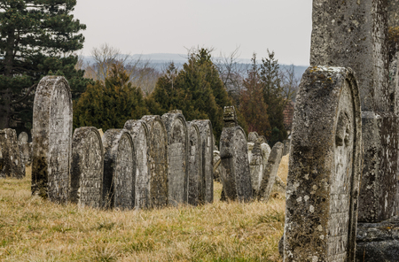 old graves in row on cemetery in the forestのeditorial素材