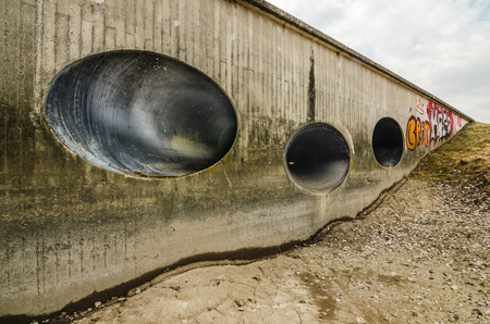 wall with three pipes from the damの写真素材