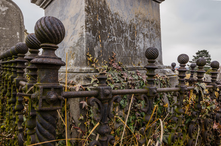 Ornate iron railing on old graveの写真素材