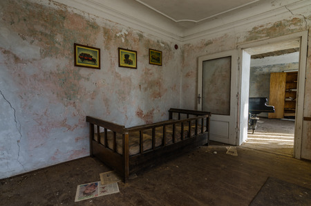 bed and pictures in old room of a houseのeditorial素材