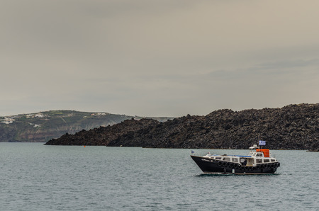 small boat in greece near an islandのeditorial素材