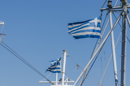 a few Greek flags on a shipの写真素材
