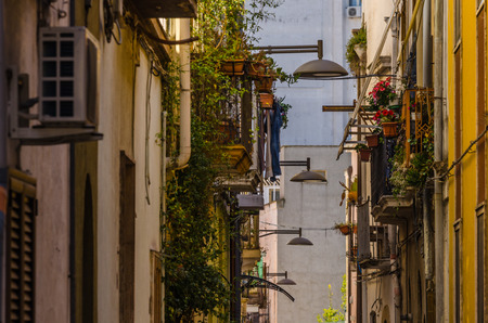 lamps and flowerpots on balconies in old townの写真素材