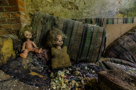 two dolls on a sofa in an old factoryの写真素材
