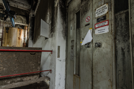 Elevator with signs in an abandoned factory