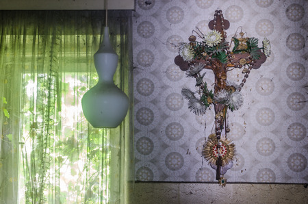 Old cross on a wall with wallpaperのeditorial素材