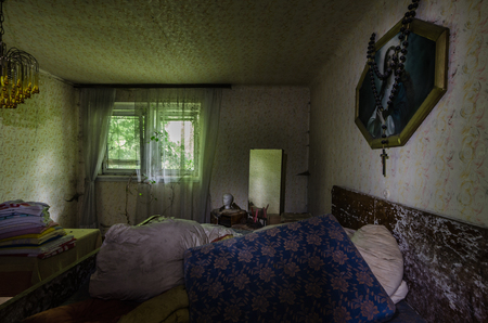 Bedroom with picture in an old abandoned houseのeditorial素材