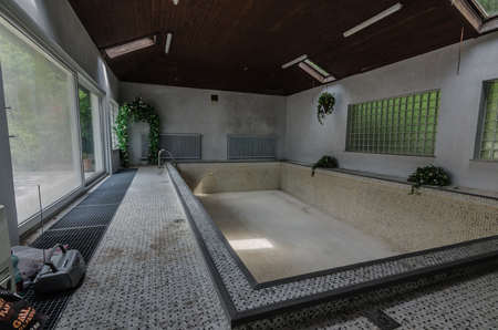 empty swimming pool in abandoned houseの写真素材