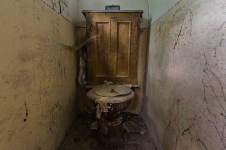wooden toilet in a deserted old houseの写真素材