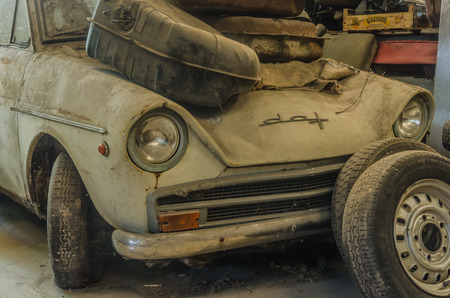 Beige car in a hall of a junkyardの写真素材