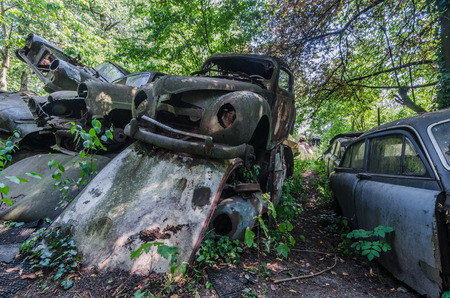 Rusty cars stacked on a junkyardの写真素材