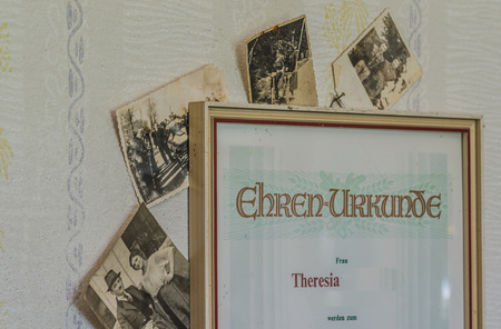 honorary certificate with photos in an abandoned house