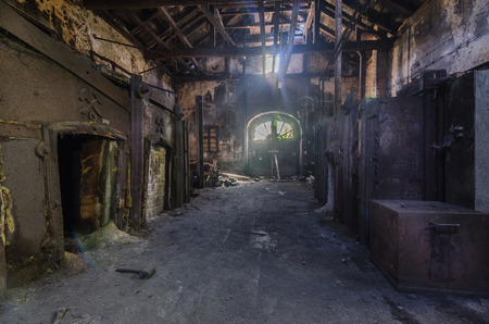 Dark foundry with light from a door