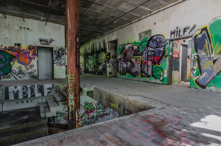 many colorful graffiti in a staircase of a factoryの写真素材
