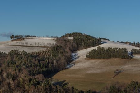 Mountains and trees with a snow layer in winter