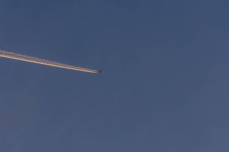 blue sky and plane at sunsetの写真素材
