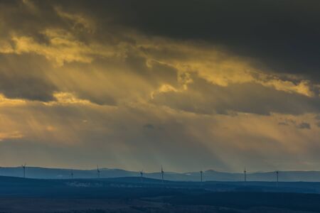 landscape with houses and windmills with sunbeams detail view