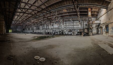 Big hall with a long machine of a factoryの写真素材