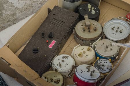 many old alarm clocks in a box in a house