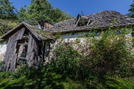 abandoned house in the mountains with forestの写真素材