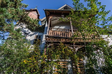 wooden balconies from an abandoned hotel in the woodsのeditorial素材