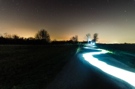 Light painting on a street with starry sky in summer