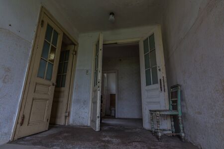 Entrance area with doors in an abandoned elementary schoolの写真素材