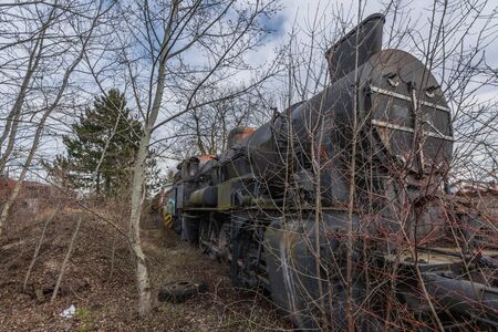 abandoned big old locomotive in nature