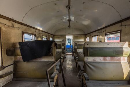 Interior benches of an abandoned wagon from a trainの写真素材