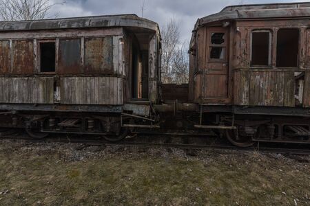 Two wooden wagons connecting on a train cemetery
