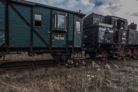green wooden wagon with windows on a railway