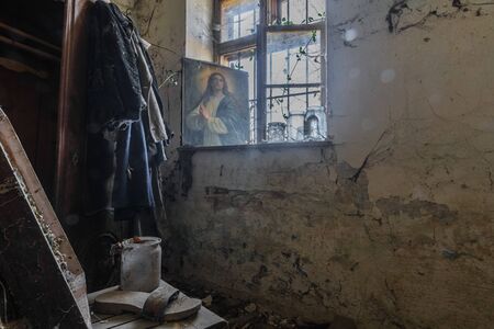 Box with robe and picture near a window in a house