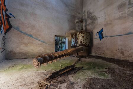 rusty long spindle in a tower of a factoryの写真素材