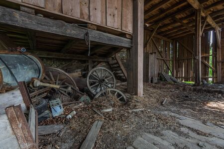 Wooden wagon wheels on an old abandoned farmのeditorial素材