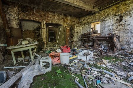 Littered room made of stone from an abandoned farmのeditorial素材