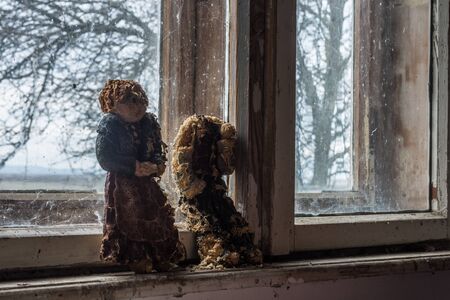 melted wax figures on a window in an old houseの写真素材