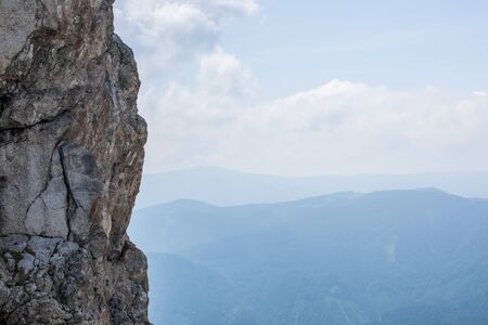 high steep rock face when climbing in summerの写真素材