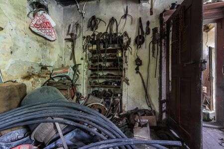 many old tools in a workshop in a abandoned house