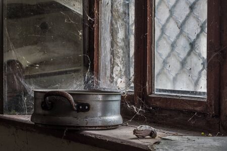 Pot of cobwebs on a window sill in an old millの写真素材