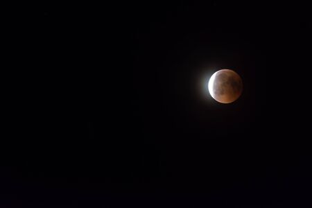 glowing sickle in a lunar eclipse in the dark night sky