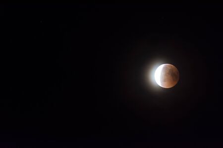bright sickle in a lunar eclipse in the sky at nightの写真素材